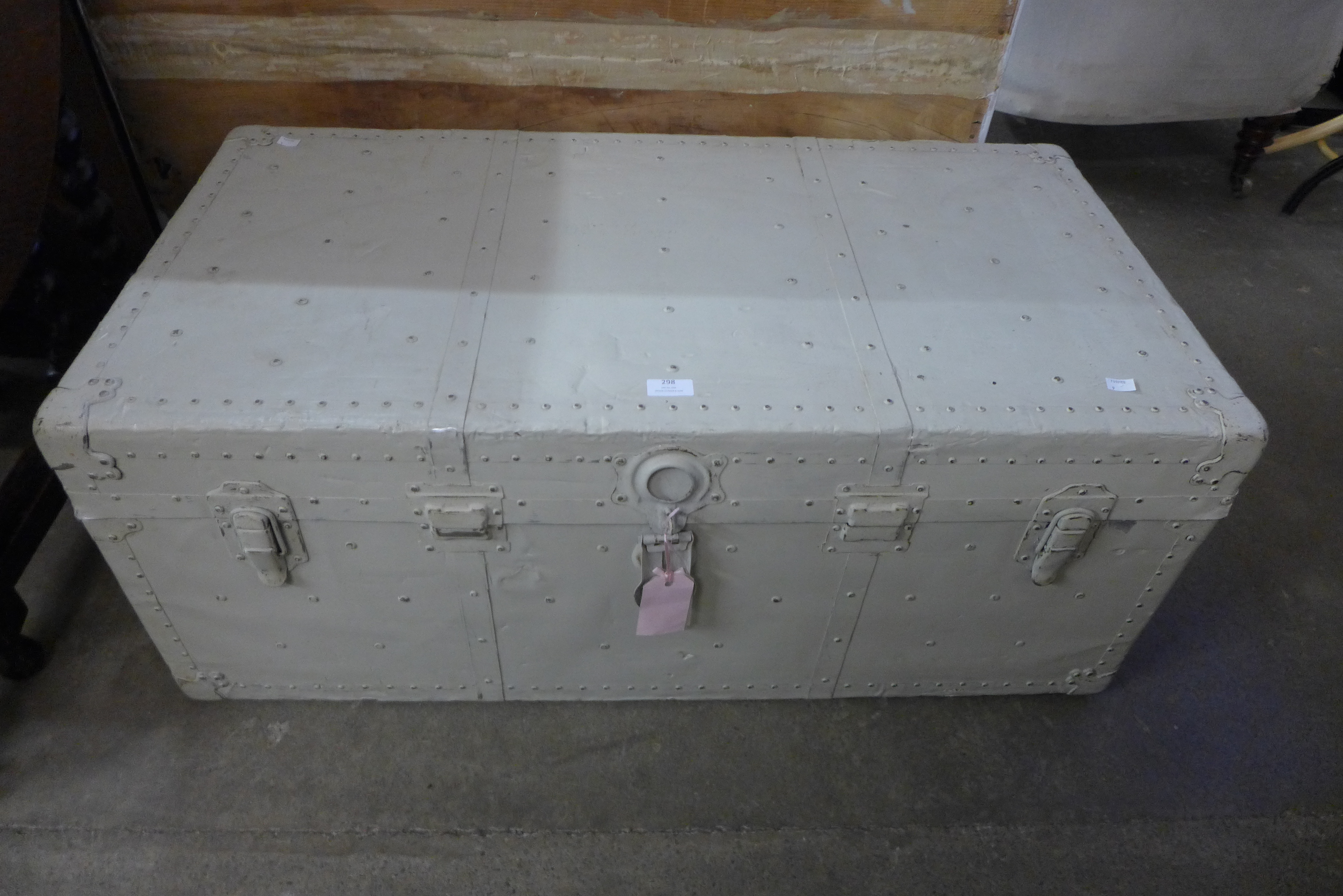 A painted metal steamer trunk