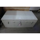 A painted metal steamer trunk