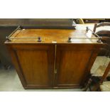 A George III mahogany cupboard and a commode