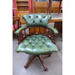 A mahogany and green leather revolving desk chair