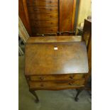 A Queen Anne style burr walnut bureau de dame