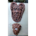 Two painted concrete wall masks