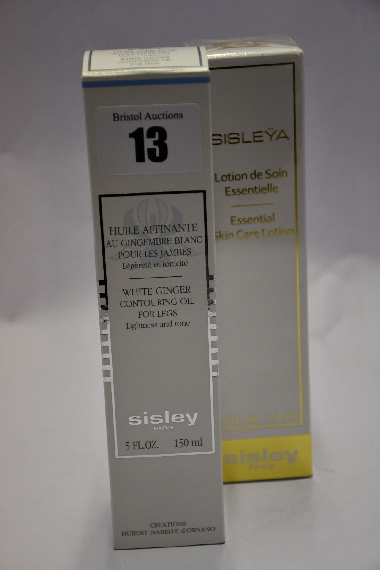 An as new Sisley essential skin care lotion (150ml) and an as new Sisley white ginger contouring oil