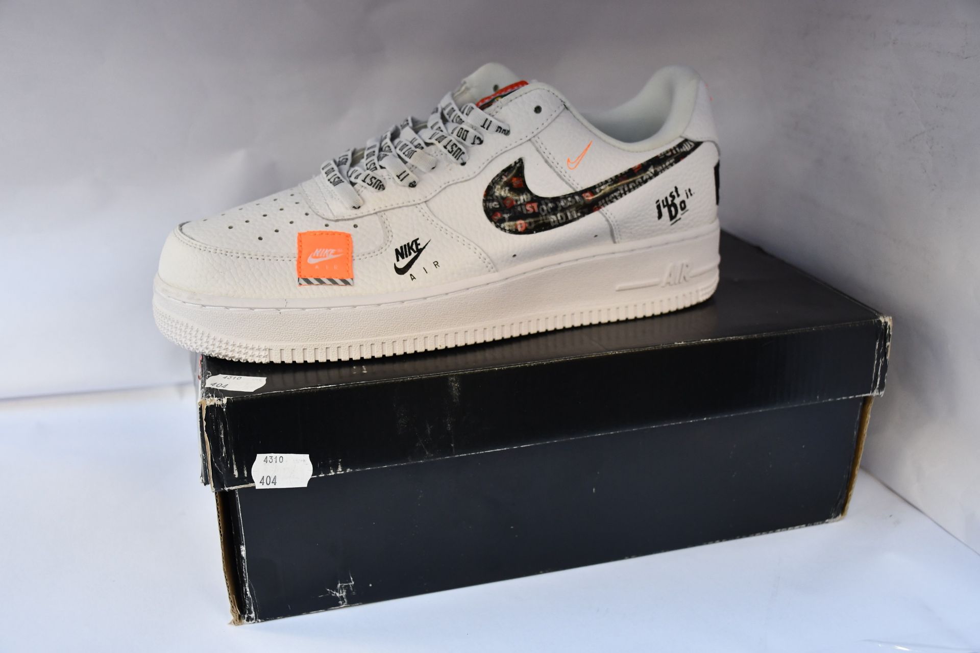 A pair of as new Nike Air Force 1 Just Do It Premium trainers (UK 9).