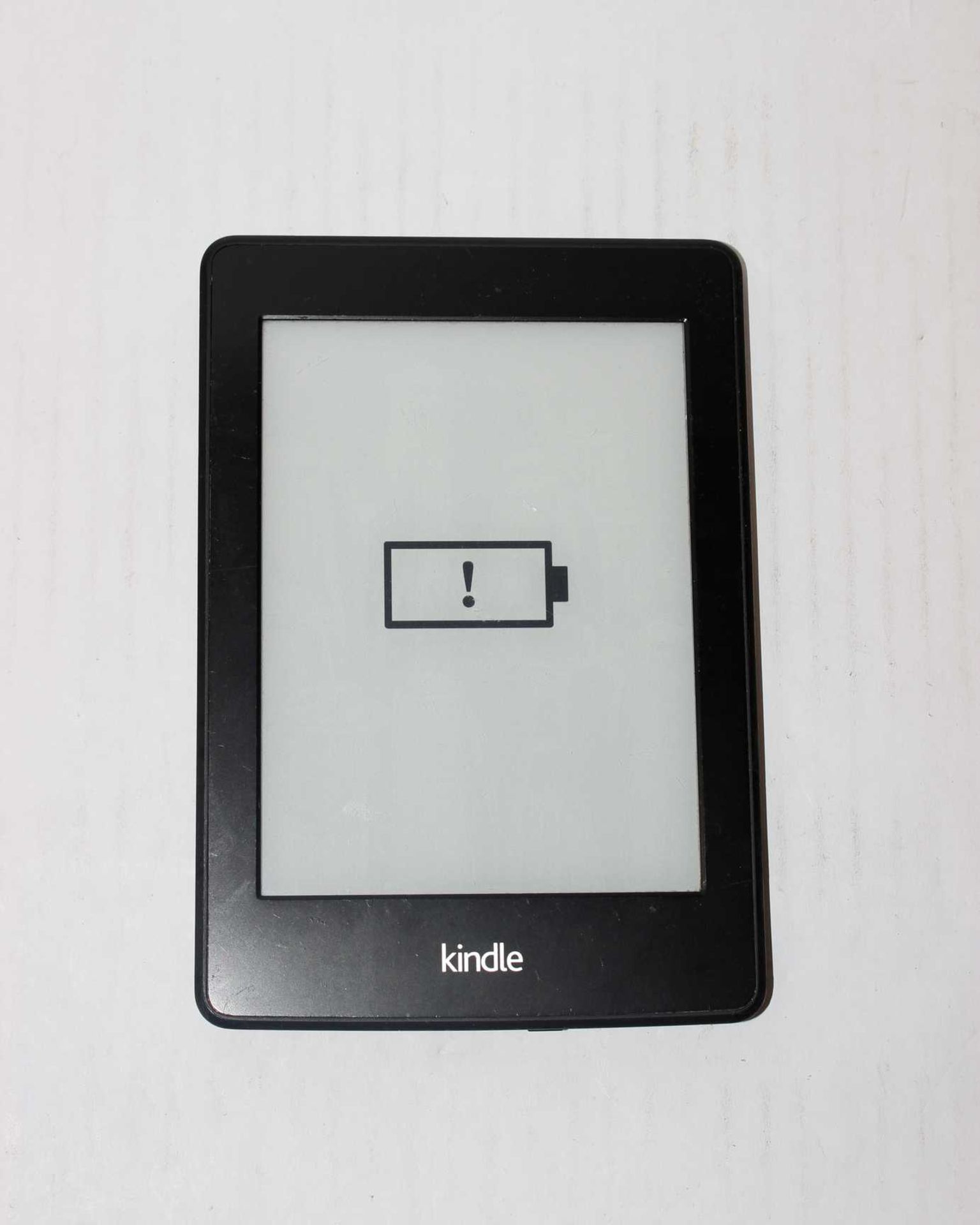 A pre-owned Amazon Kindle Paperwhite (DP75SDI) 6” E-Reader in Black (slight damage to display).