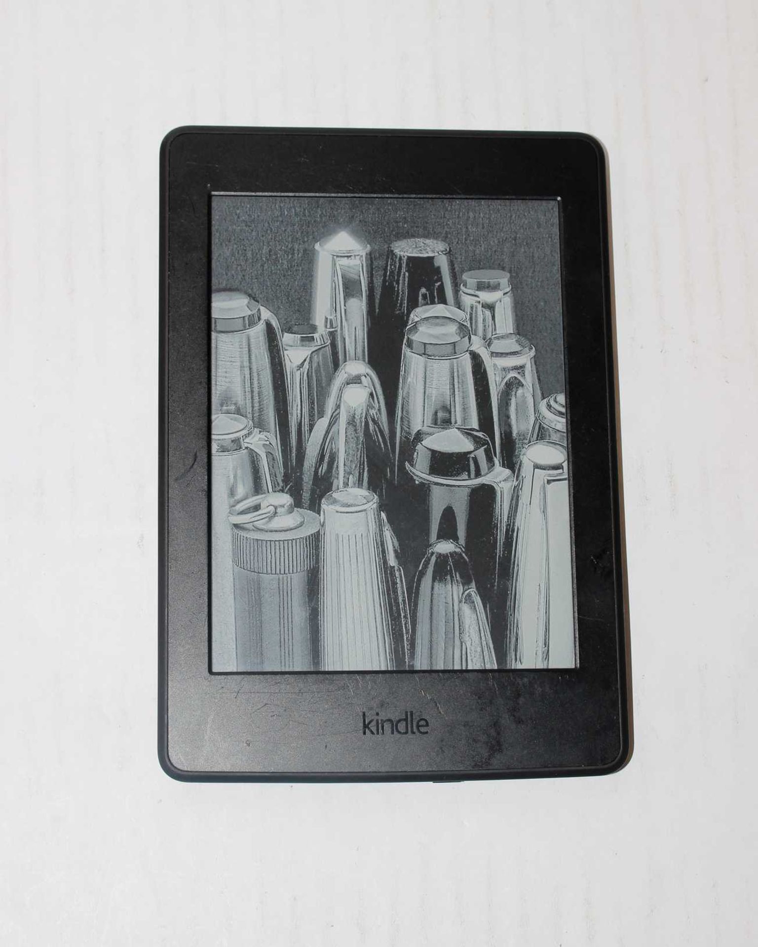 A pre-owned Amazon Kindle Paperwhite (DP75SDI) 6” E-Reader in Black (slight damage to display).