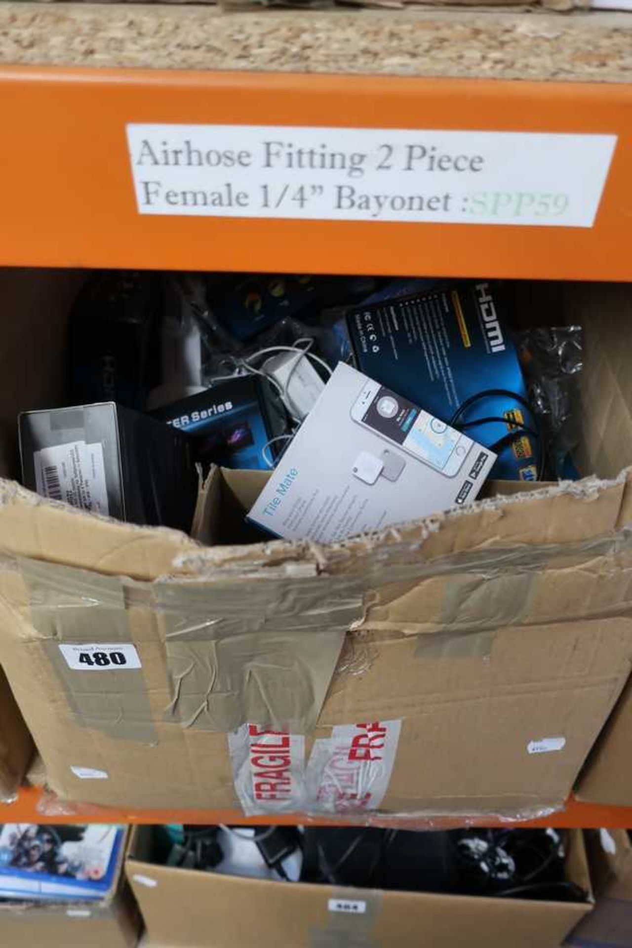 A box of assorted new and pre-owned small electrical items and accessories.