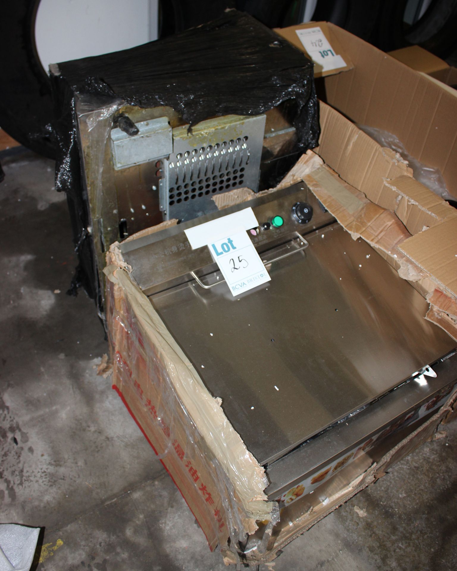 A stainless steel double fryer and another sold for parts.