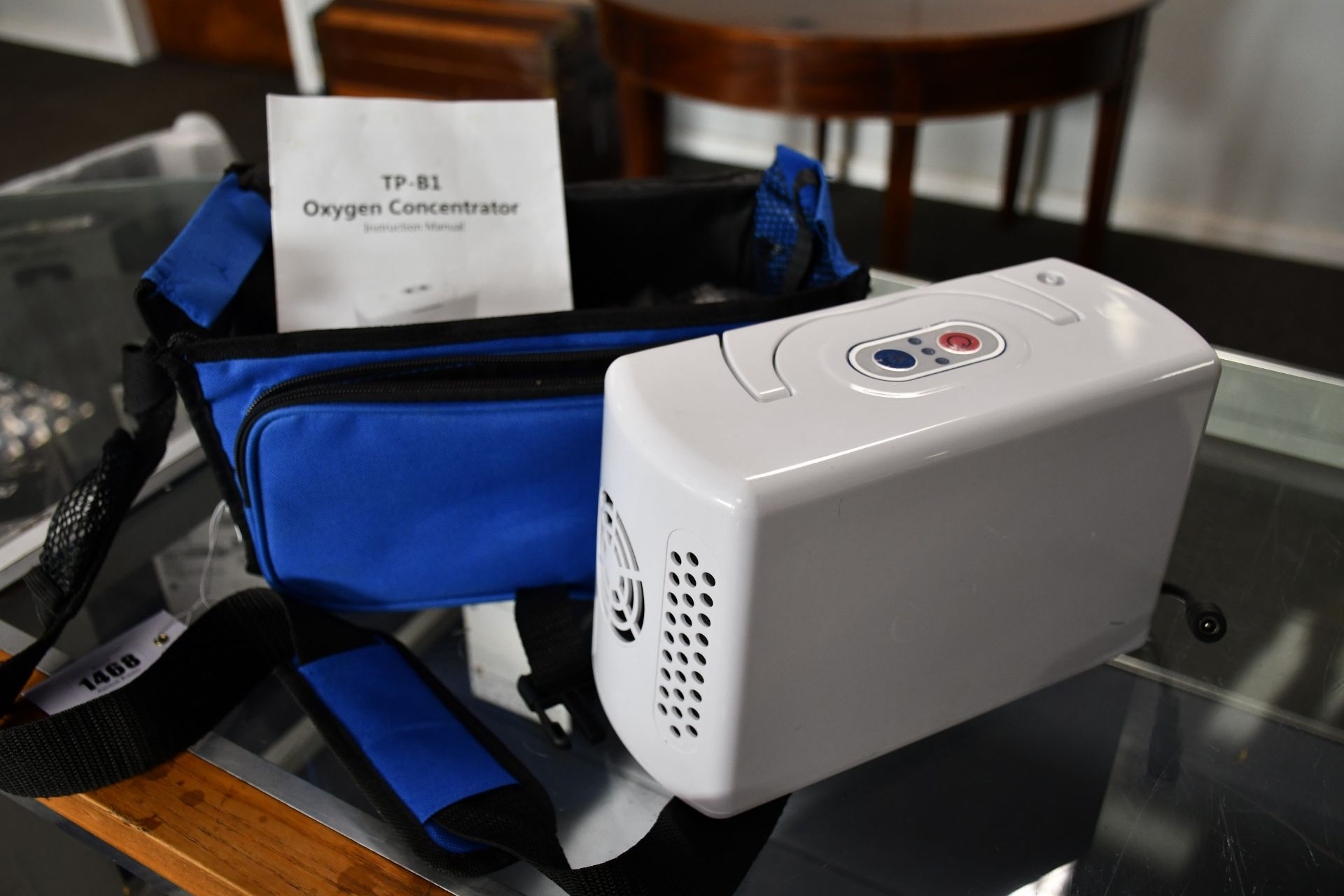 A pre owned TP-B1 Portable Oxygen Concentrator with power supply and carry bag.