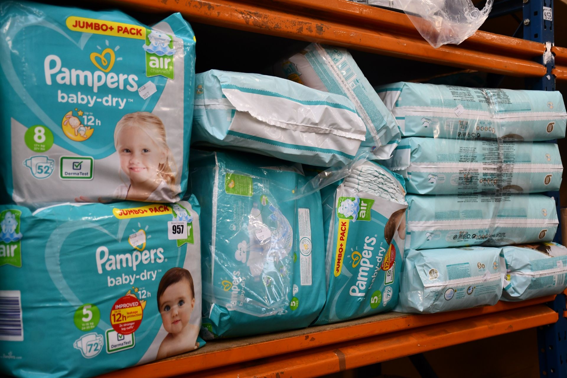 One shelf containing assorted Pampers disposable nappies and related items.