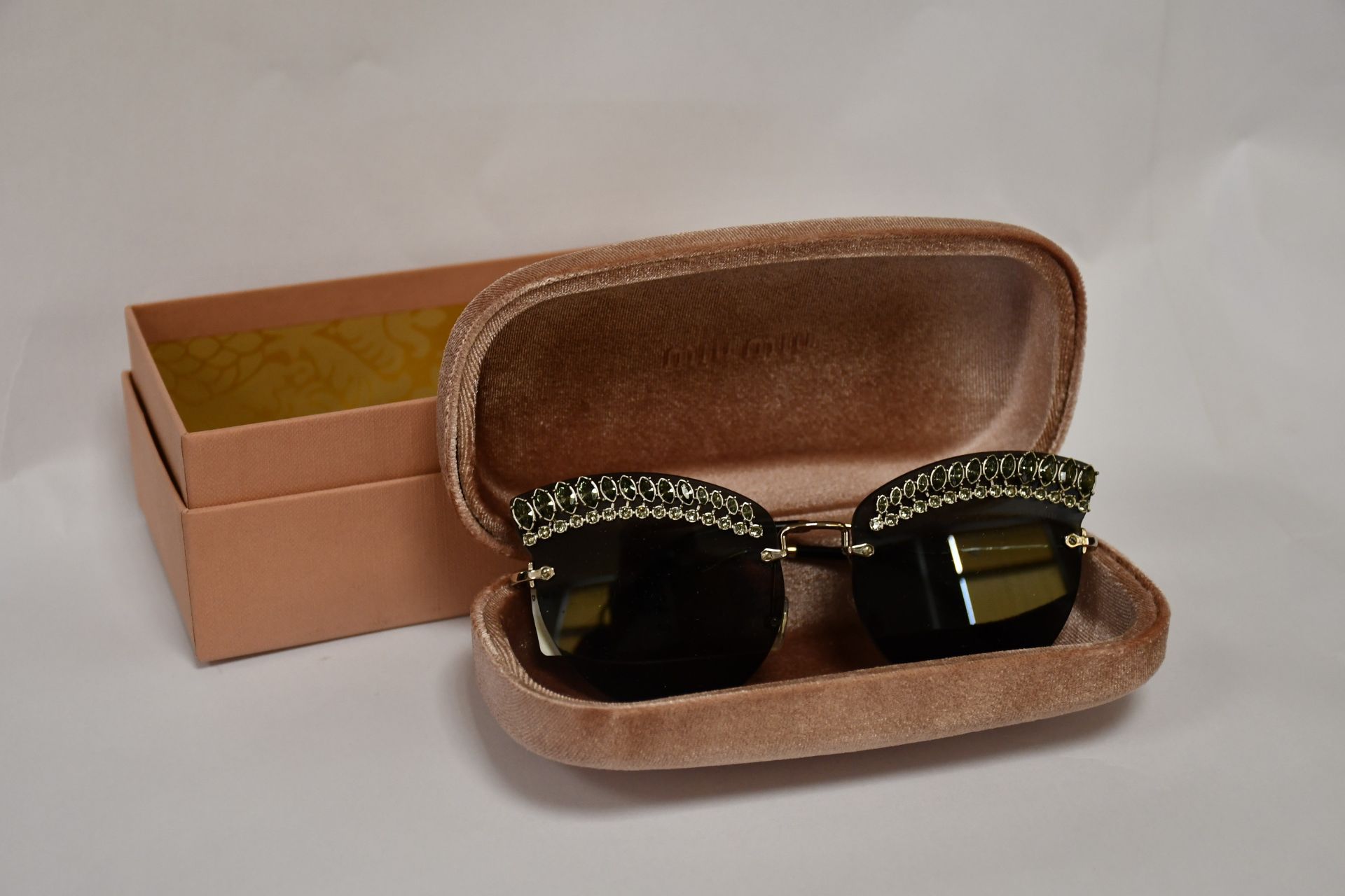 A pair of as new Miu Miu sunglasses.