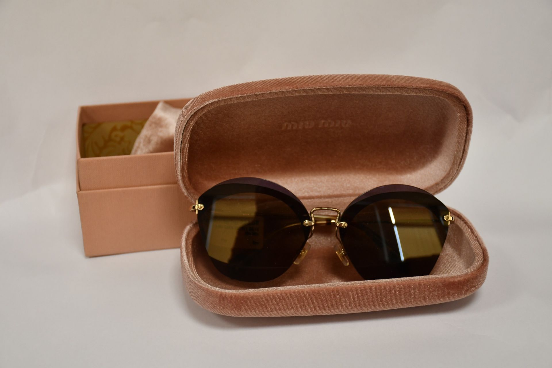 A pair of as new Miu Miu sunglasses.