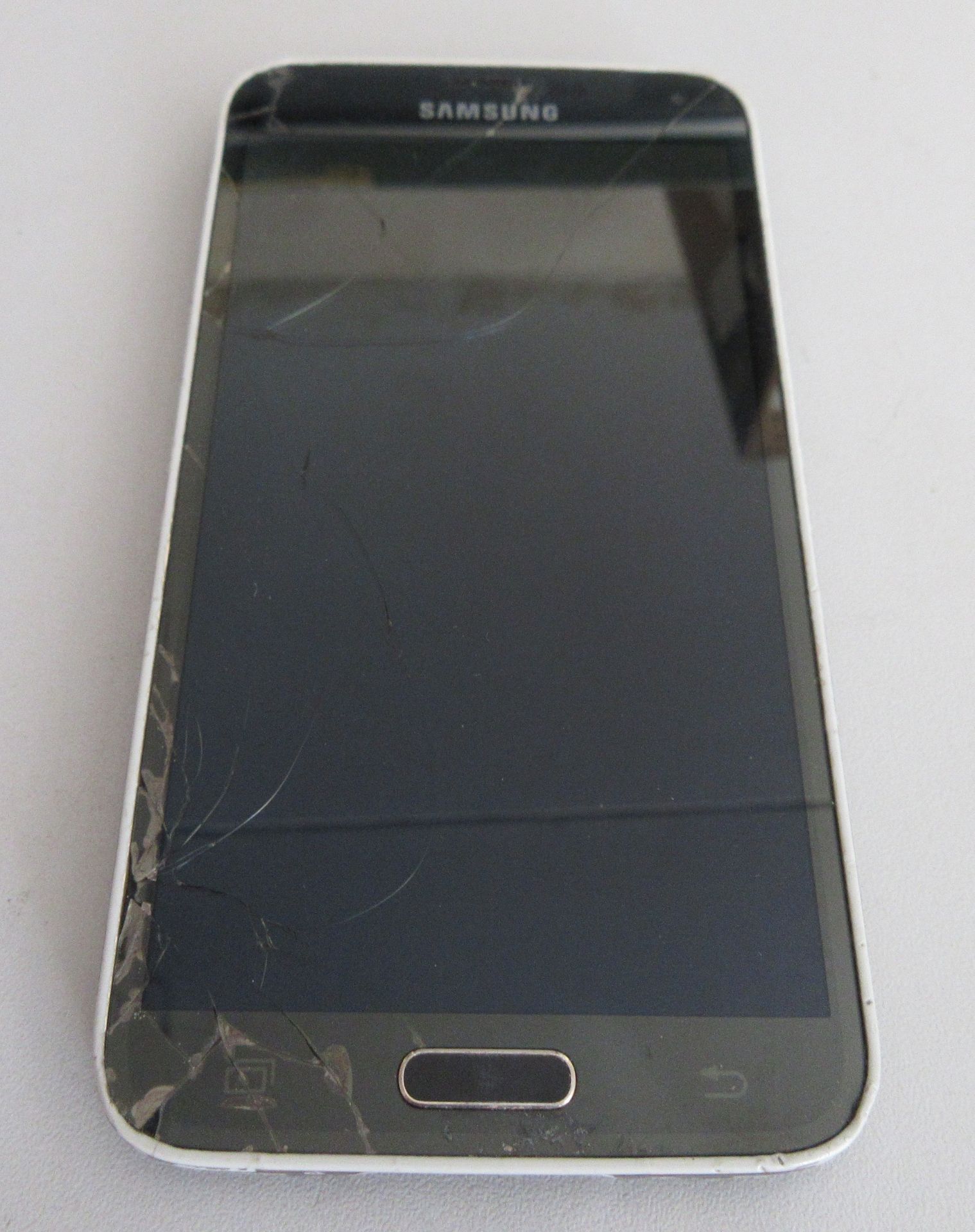 A used Samsung Galaxy S5 Android mobile phone SM-G900F. Screen and rear damaged. Activation clear.