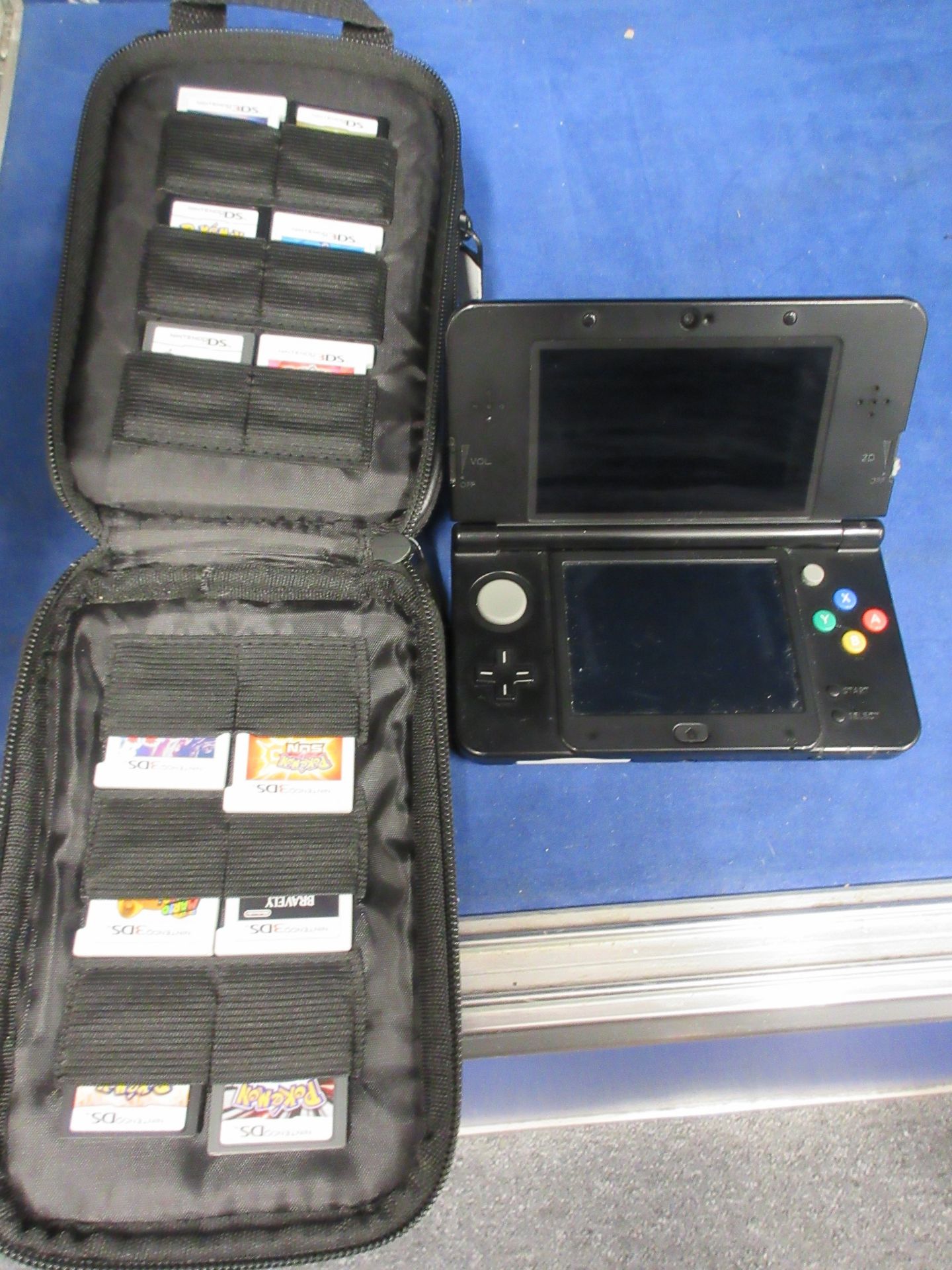 A pre-owned Nintendo 3DS Handheld Console ('New' version) in Black with thirteen assorted game cards