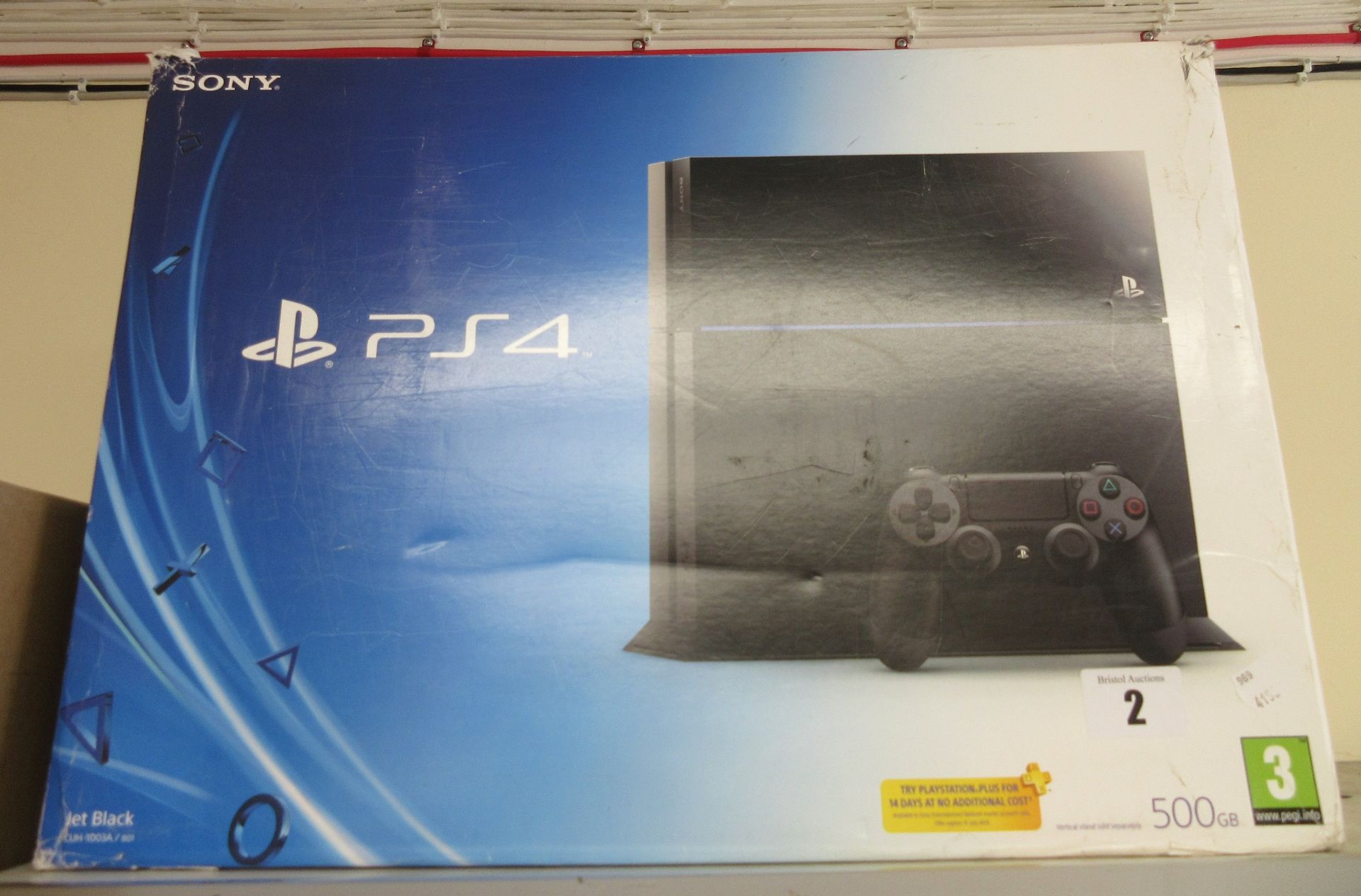 A pre-owned Sony PlayStation 4 500GB Jet Black Console and two controllers in box.