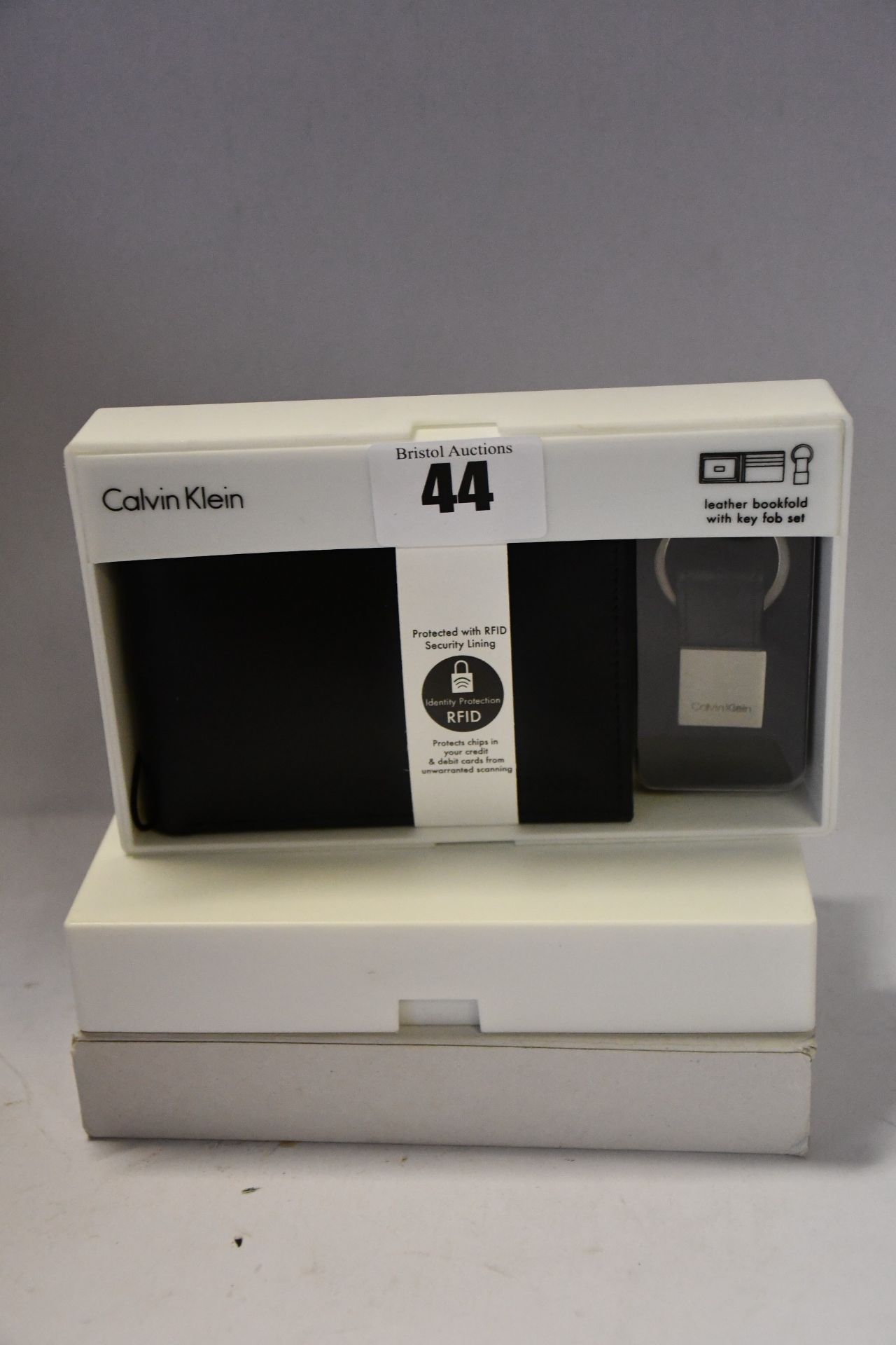 Three boxed as new Calvin Klein leather bookfold wallets with key fob sets in black.