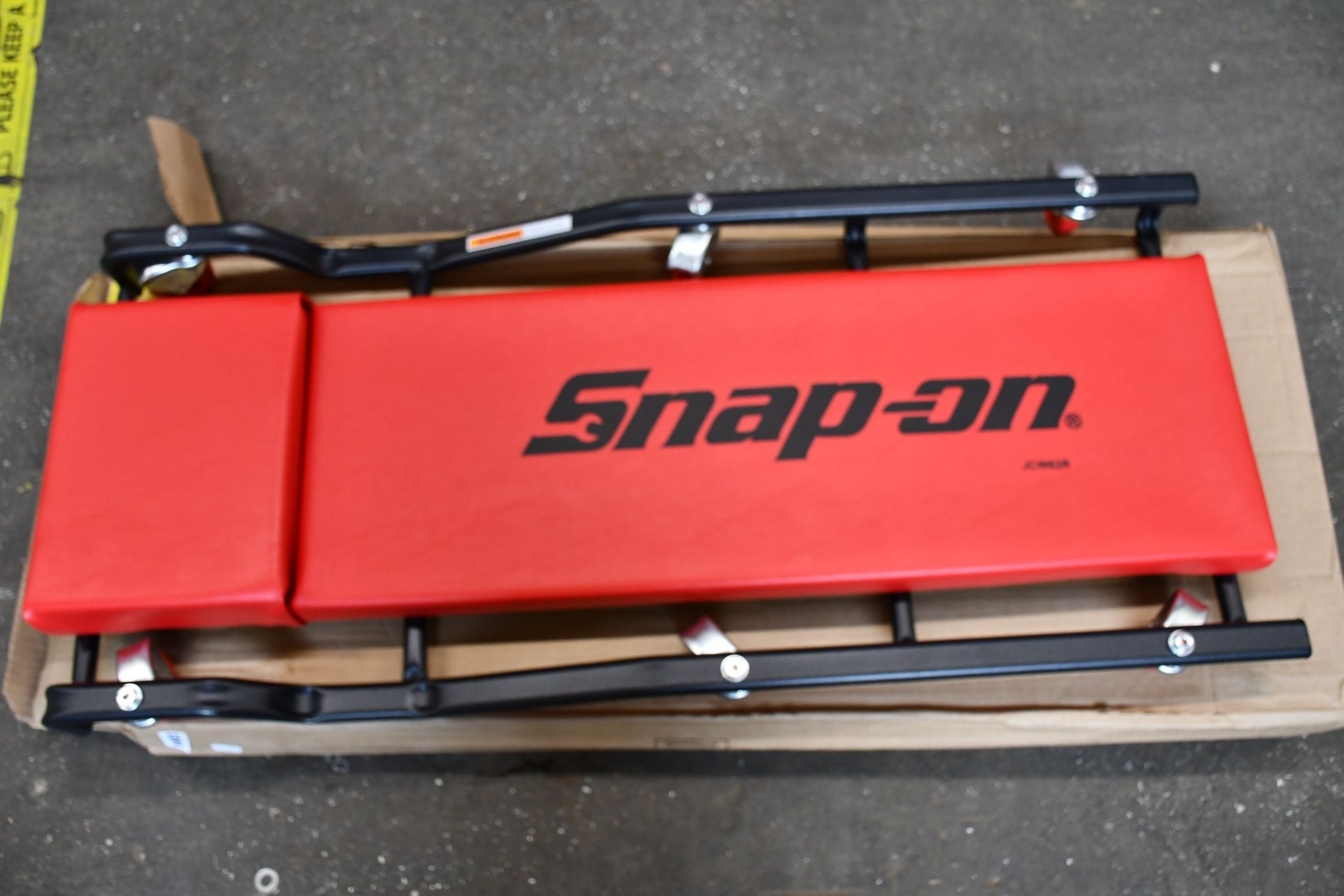 One boxed as new Snap-On Standard Creeper (JCW62R) in red.