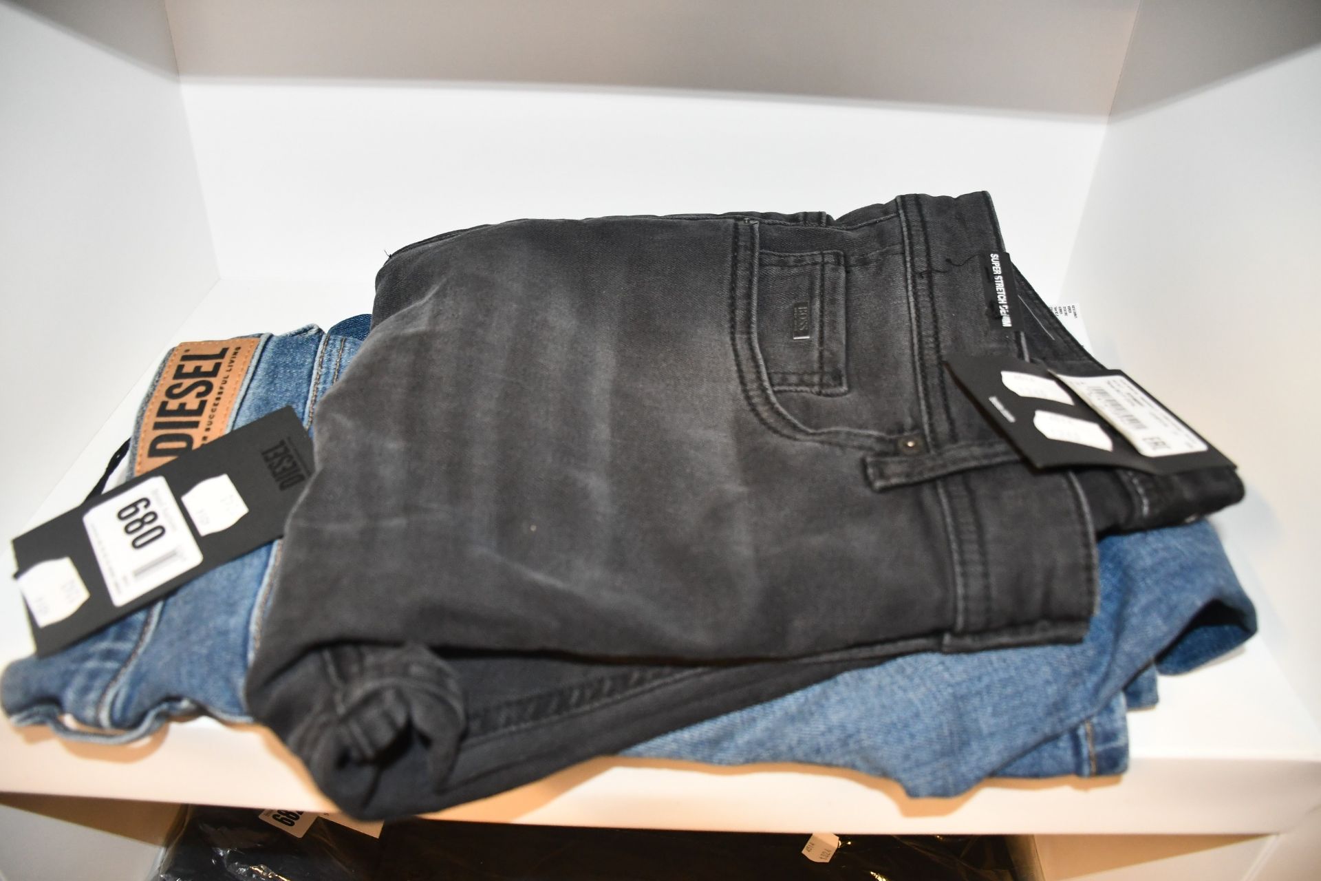 A pair of as new Hugo Boss jeans (W35/L34) and a pair of Diesel jeans (W25/L32).
