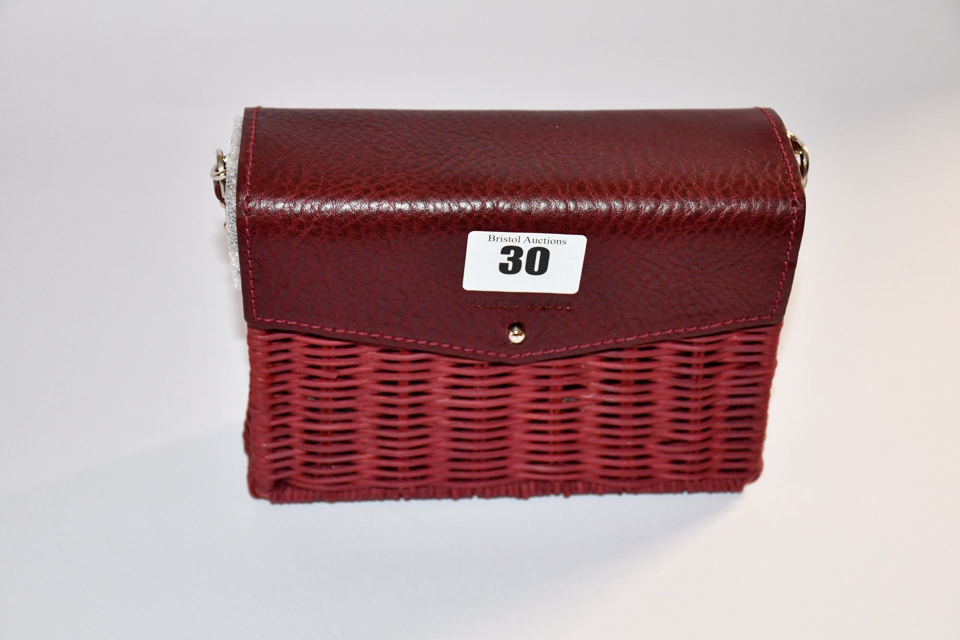 An as new Wicker Wings minis shoulder bag in burgundy.