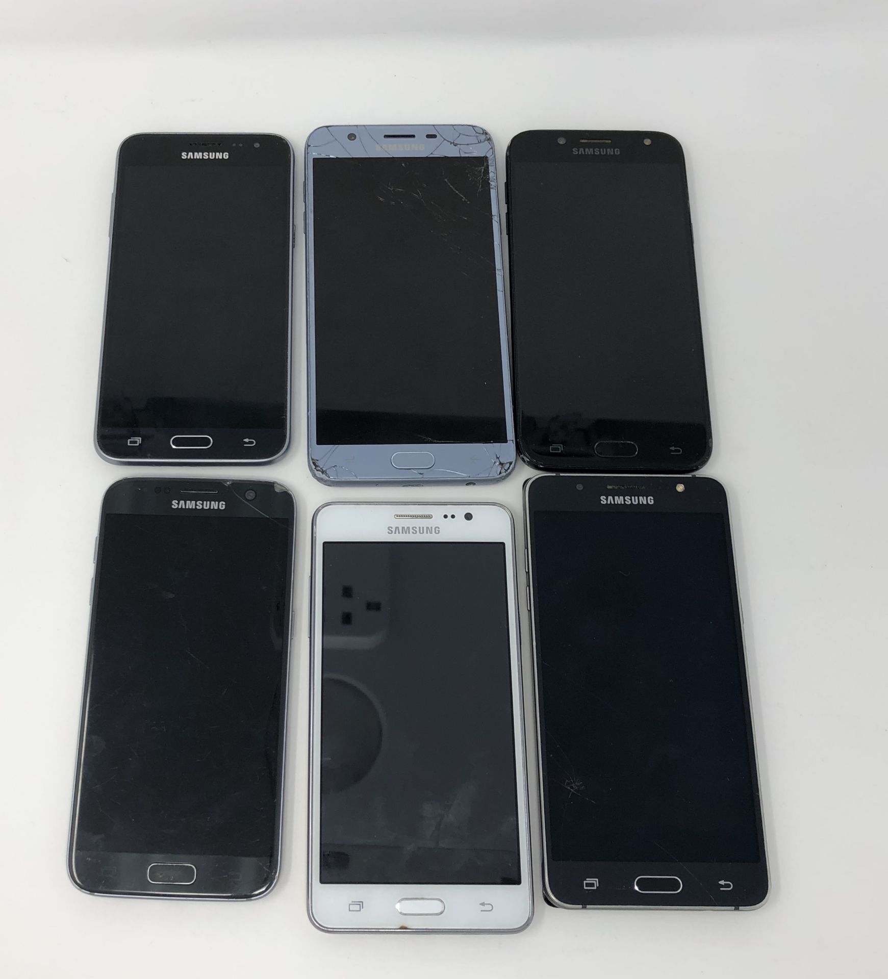 Six assorted pre-owned Samsung smartphones sold for parts; 1x Galaxy S7 SM-G930F, 1x Galaxy J5 PRO