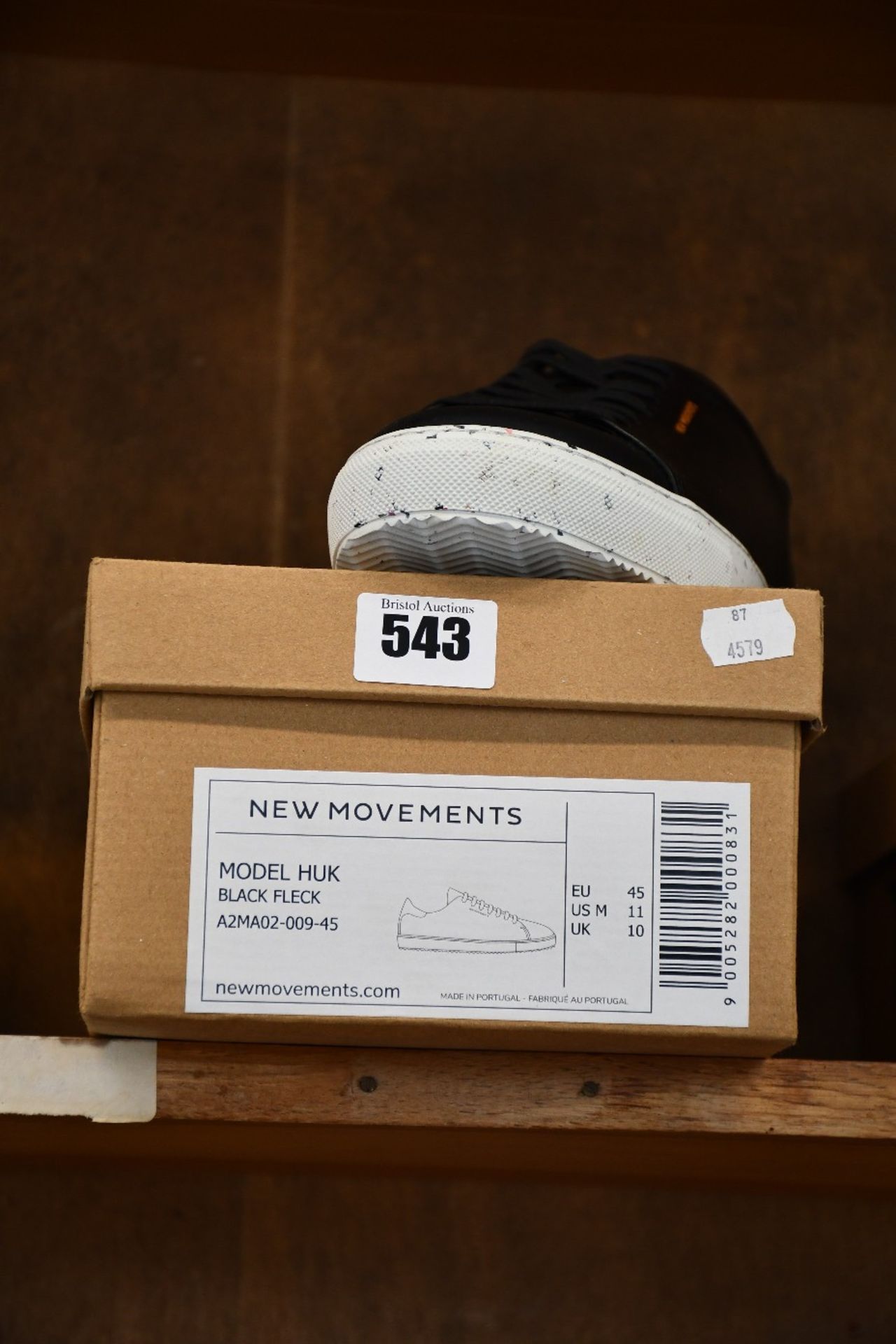 A pair of as new New Movements Huk trainers in black fleck (UK 10).