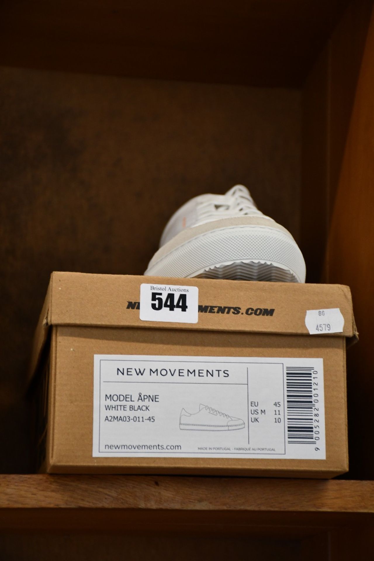 A pair of as new New Movements Apne trainers in white/black (UK 10).