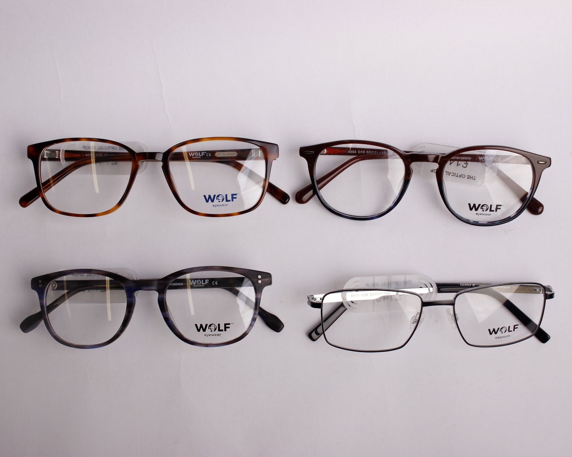 Four pairs of as new Wolf glasses frames with clear glass (RRP £140 each).