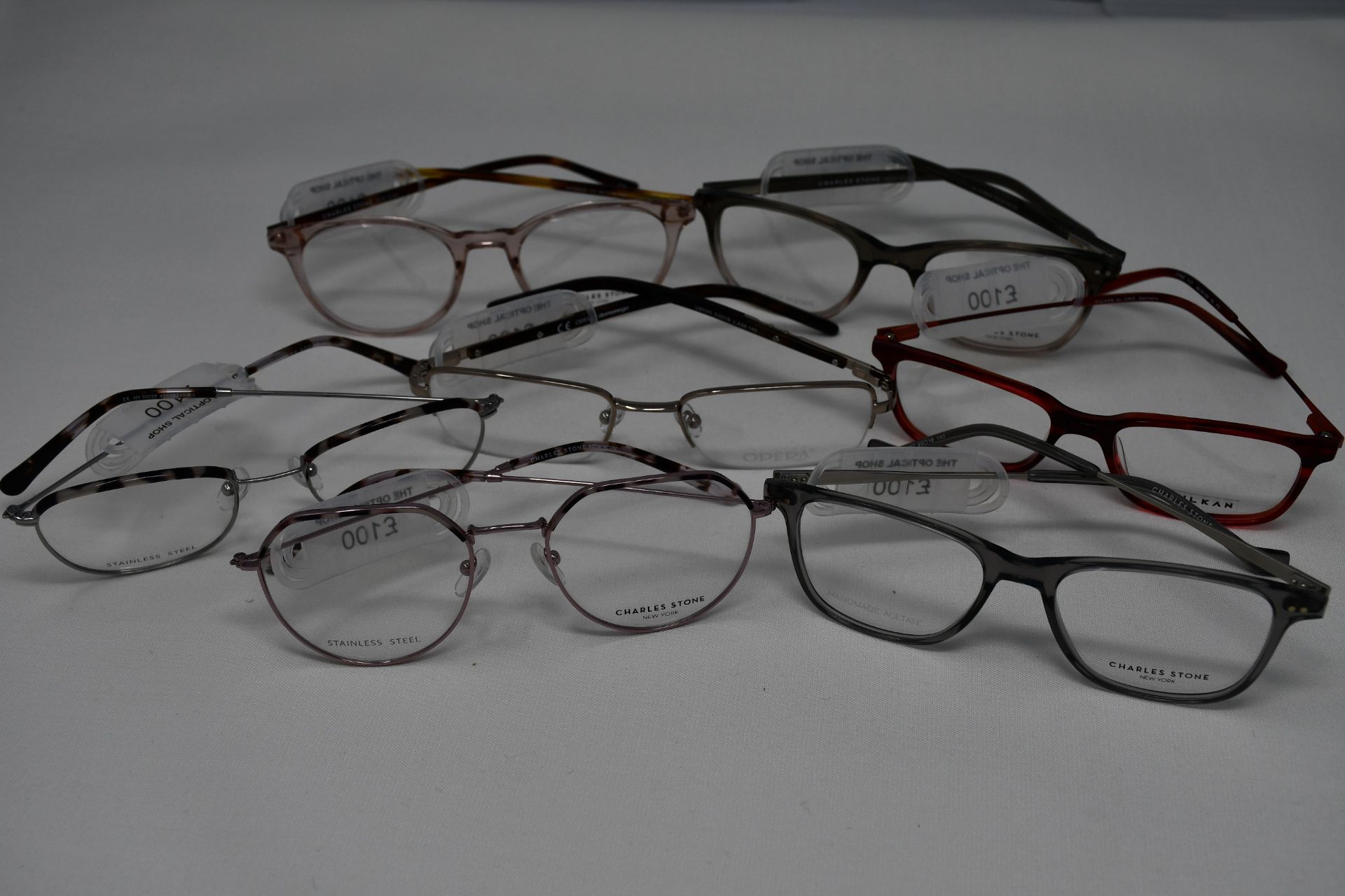 Seven pairs of as new glasses frames with clear glass to include Charles Stone, Vulkan and Opera (