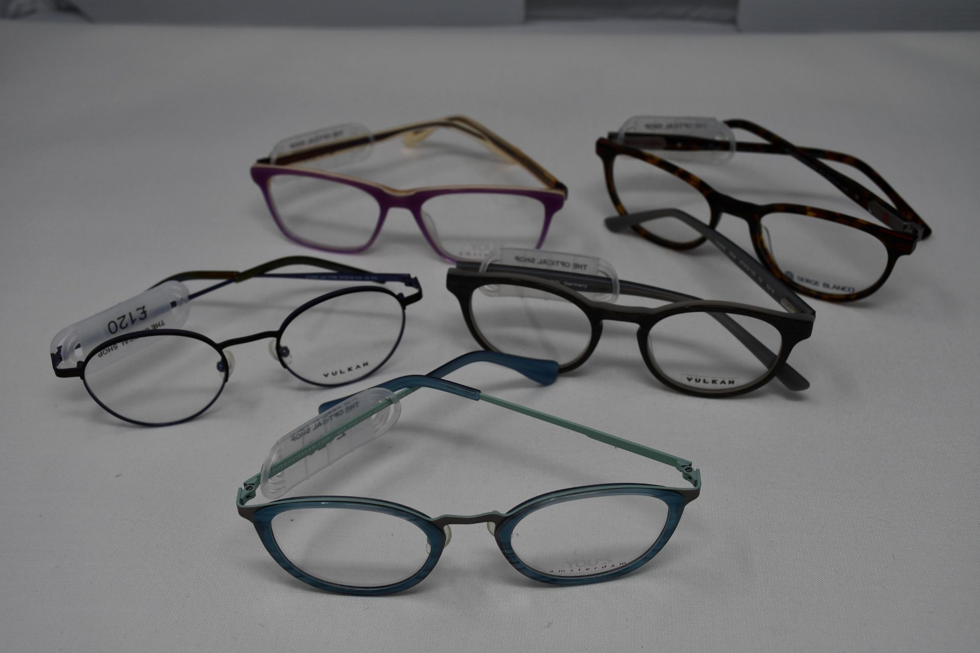 Five pairs of as new glasses frames with clear glass to include Yous, Serge Blanco and Vulkan (