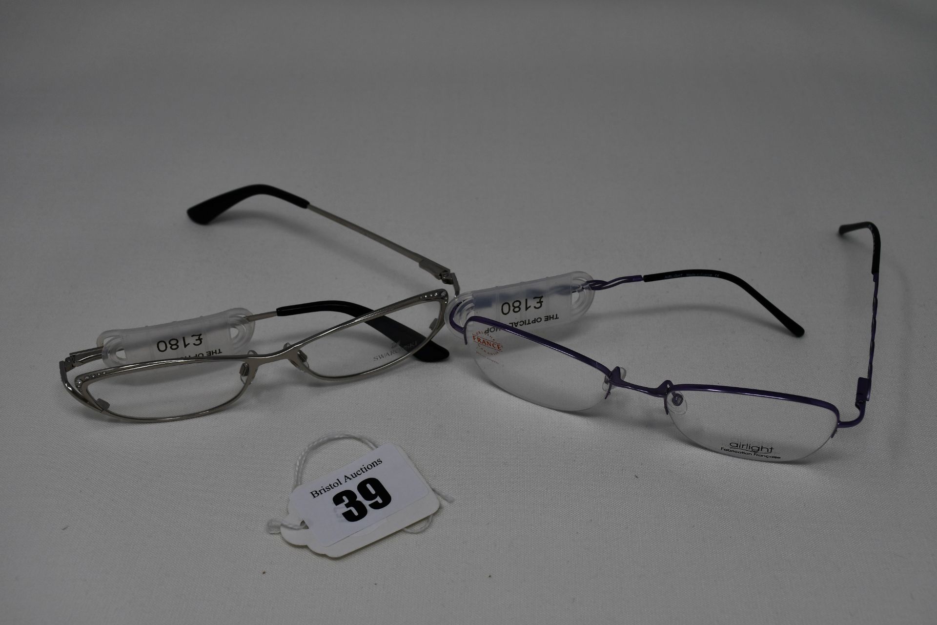 Two pairs of as new glasses frames with clear glass; Airlight and Swarovski (RRP £180 each).