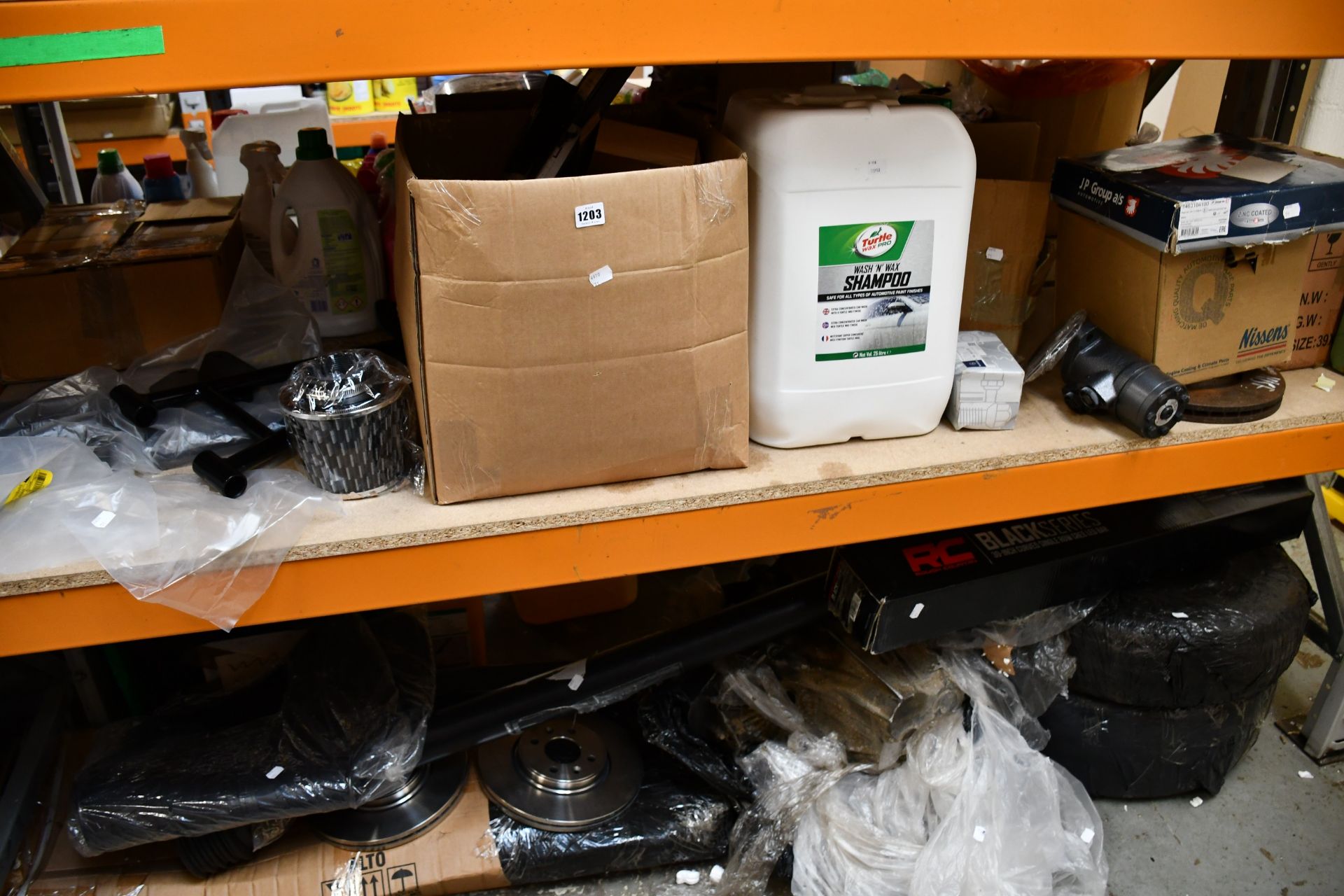 Two shelves of miscellaneous car parts and related items to include one Nissens interior blower