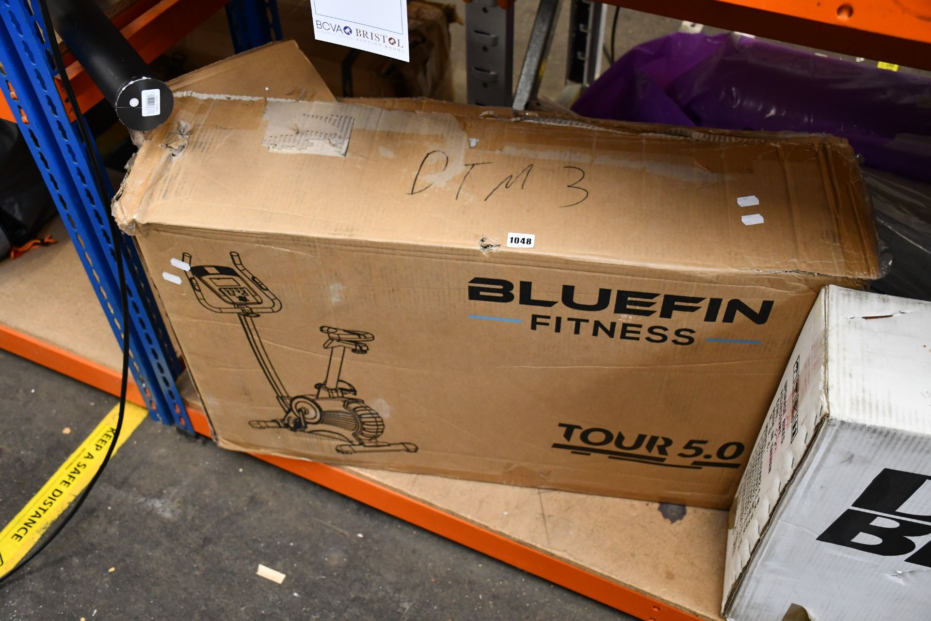 One boxed Bluefin Fitness Tour 5.0 exercise bike.