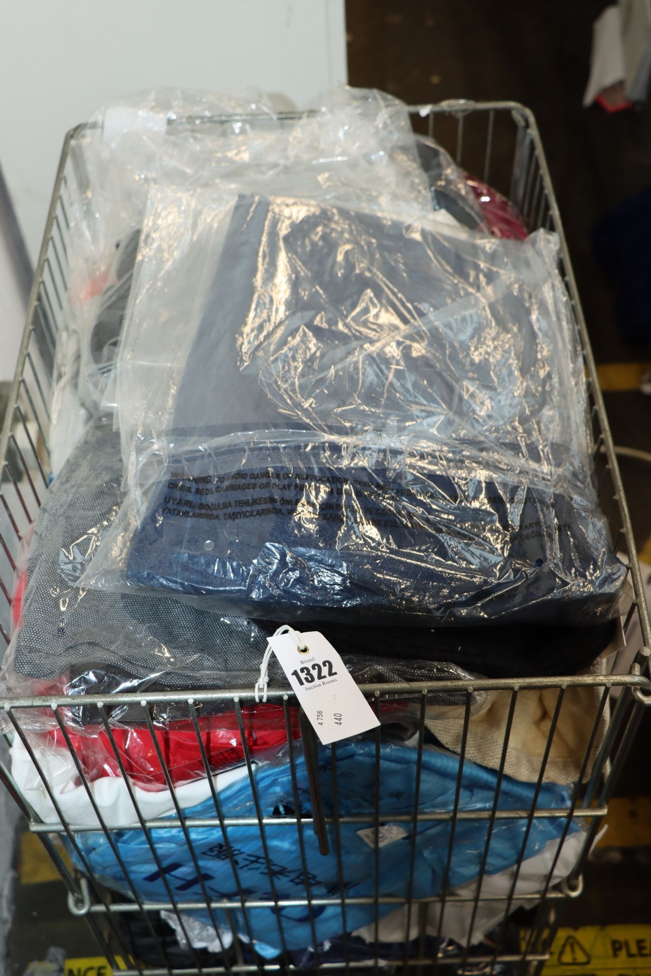 A large quantity of as new clothing and related items to include: shirts, jacket and bag.