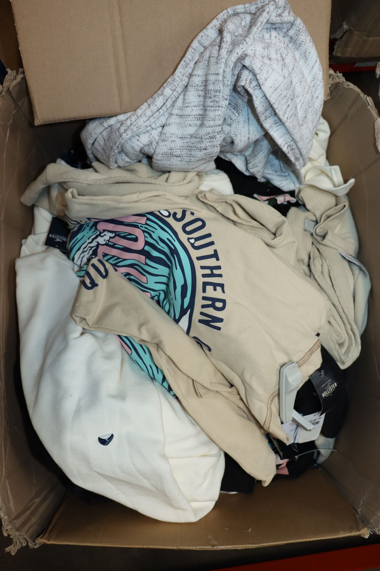 One box containing a large quantity of as new assorted Hollister clothing (Approximately 40 items,