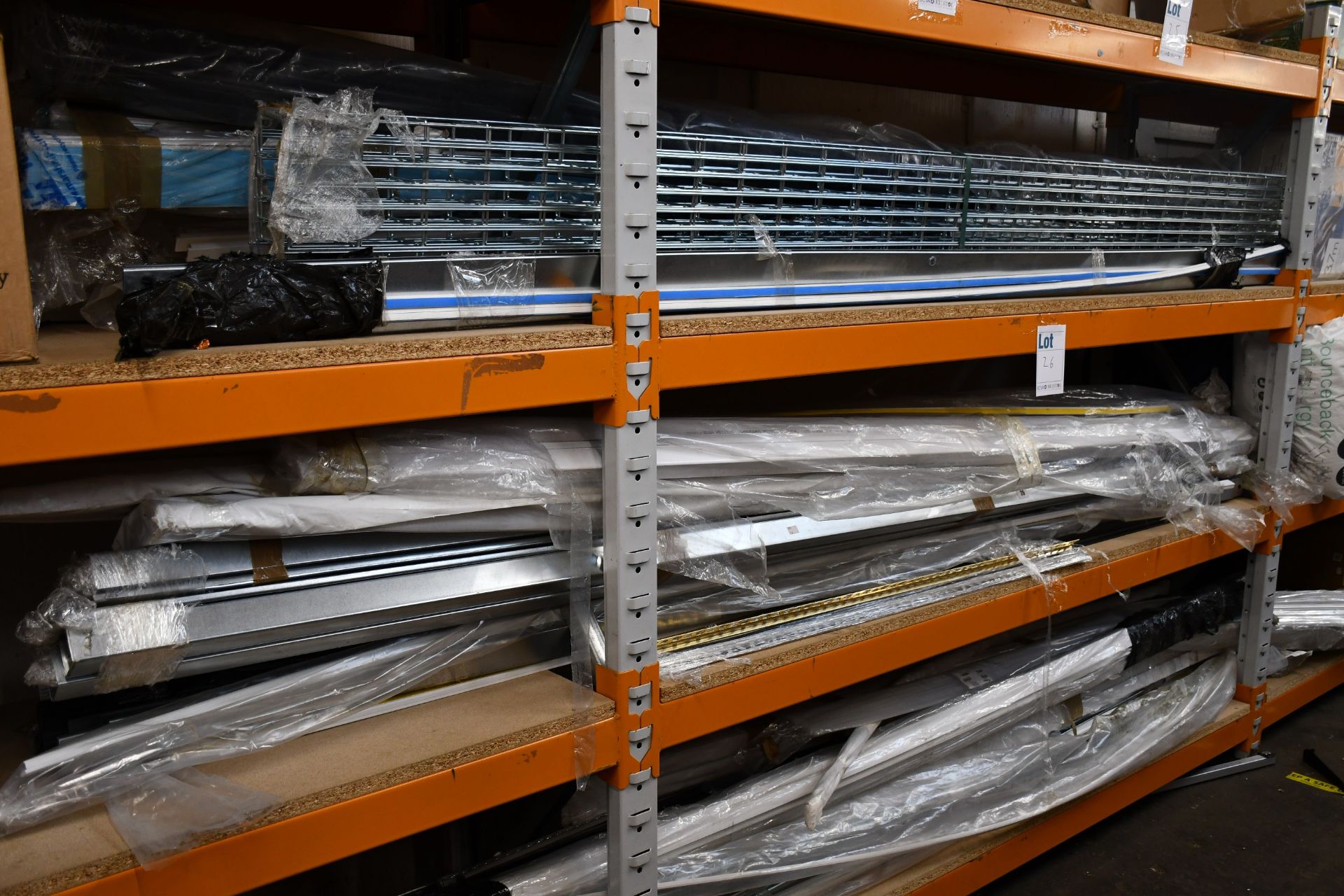 A shelf of miscellaneous items to include plastic tubing and metal support brackets.