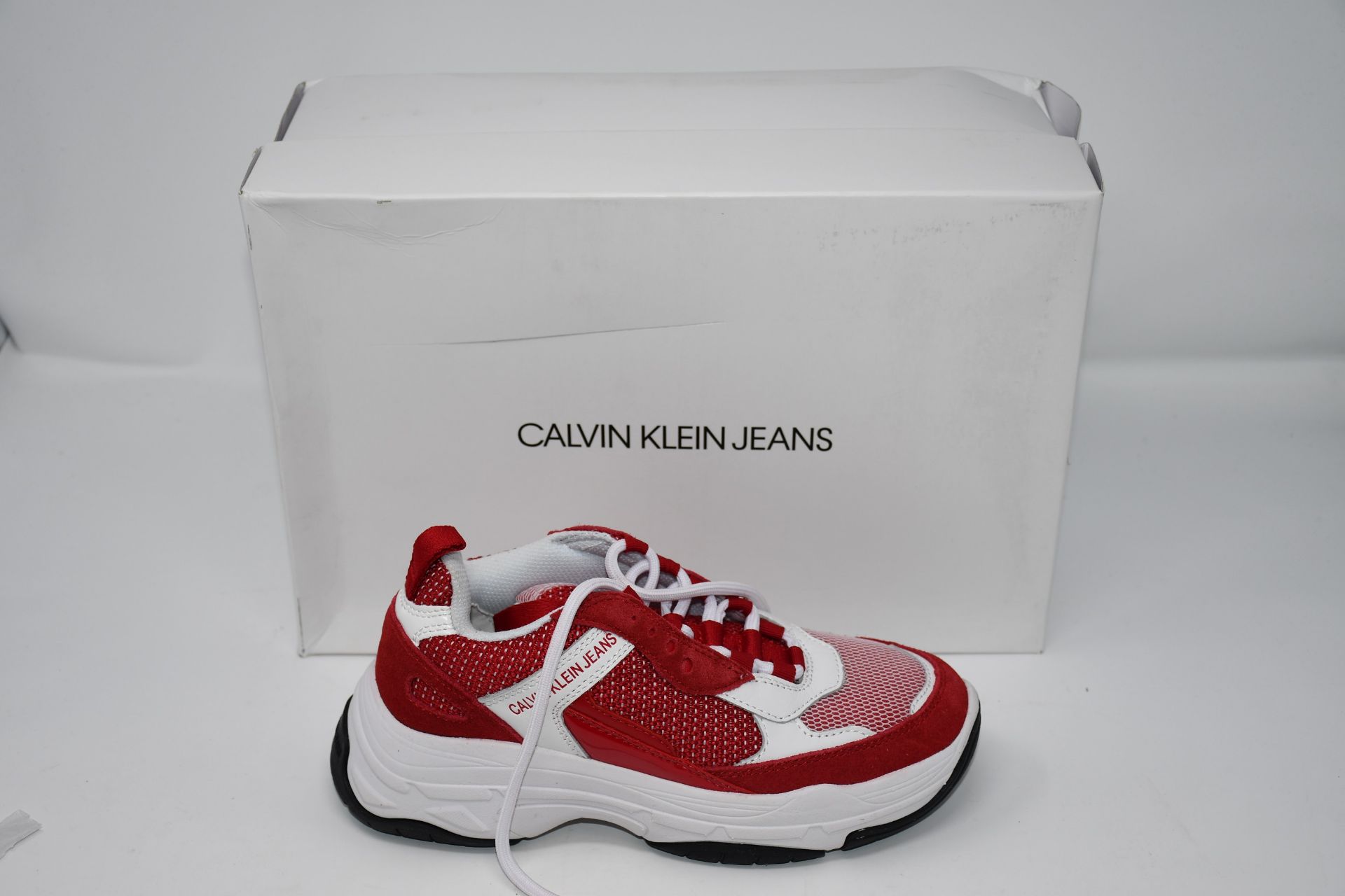 A pair of children's as new Calvin Klein white/red trainers (Size 36).