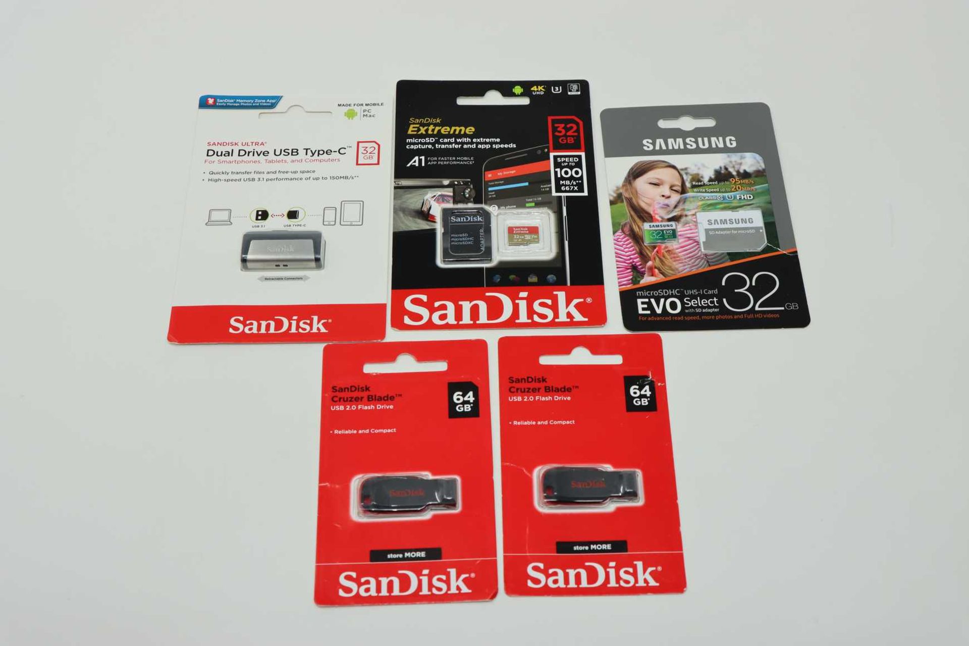 Two as new SanDisk 64GB Cruzer Blade USB 2.0 Flash Drives, an as new SanDisk Ultra Dual Drive USB