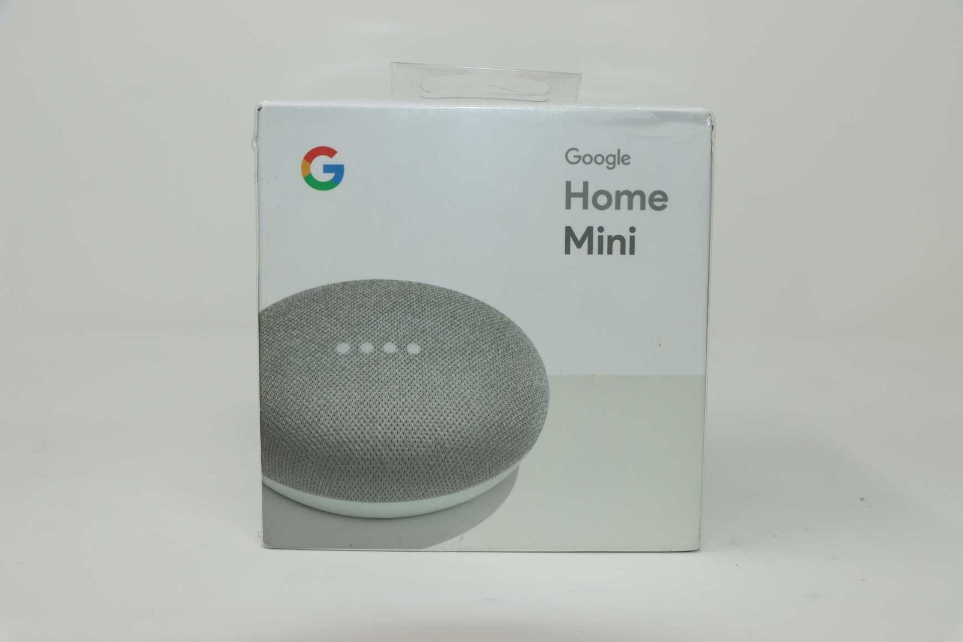 A boxed as new Google Home Mini GA00210-UK in Chalk (Box sealed, slight cosmetic damage to box)