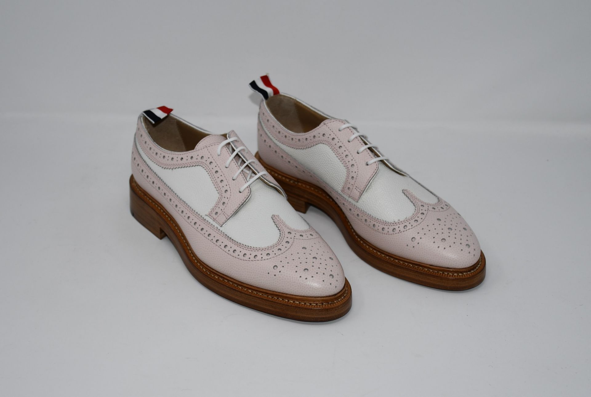 One as new Thom Browne Longwing Spectator Brogue shoes in light pink (EU size 38).