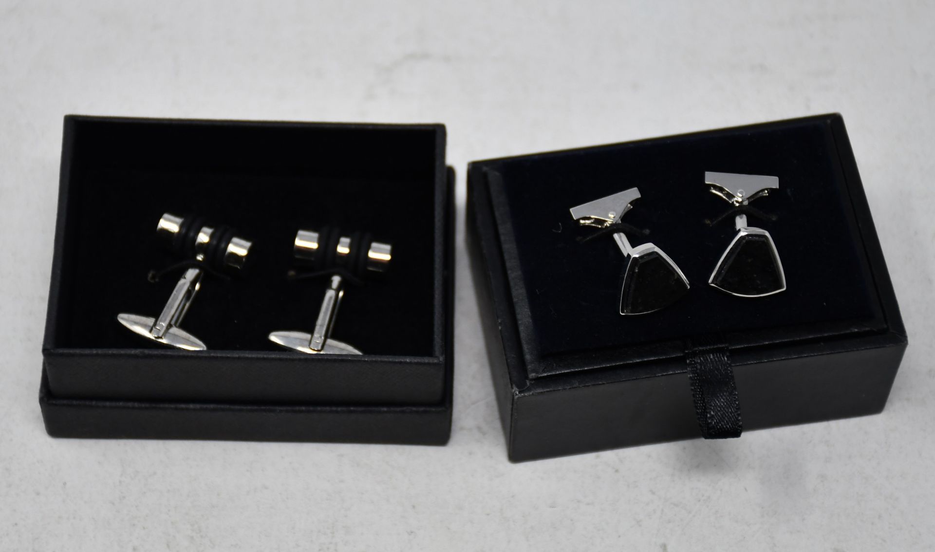 One pre-owned Massimo Dutti cufflinks. One pre-owned Martin & Co shirt cufflinks.