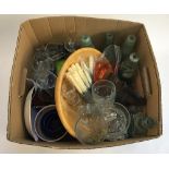 A mixed lot to include a number of vintage glass bottles, glassware, flatware, several