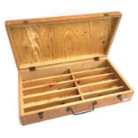 A wooden box with carry handle, interior divided into 10 sections
