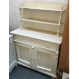A painted pine cottage style kitchen dresser with plate rack over long drawer and cupboard base,