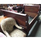 A 19th century mahogany French sleigh bed, the front with carved floral decoration and bead