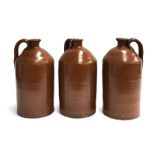 A trio of stoneware flagons with loop handles and gouged pouring spout, 34cmH (3)
