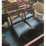 A set of four mid-century beech and black vinyl upholstered kitchen chairs