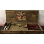 A 'Skill Ball' vintage putting game in wooden box containing two vintage golf clubs, 'British Made