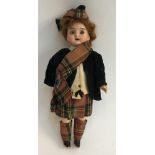 A small doll with bisque head and brown sleeping eyes, wearing Scottish garb, marked '21, Gcf III