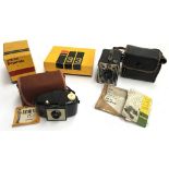 A Kodak Brownie 127 camera in case with instructions; a Kodak six-20 brownie in carry case with