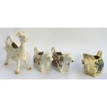 A Beswick cow creamer decorated with floral pattern; together with two Crown Devon cow creamers